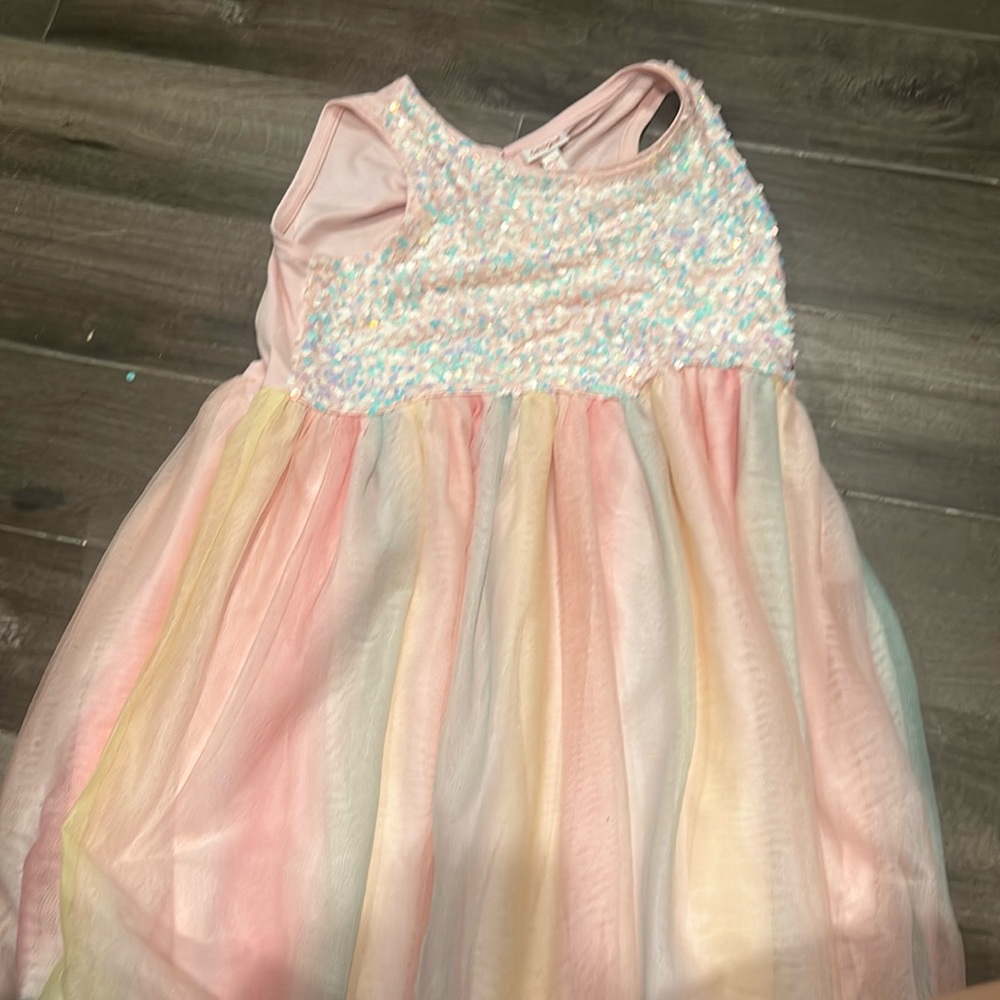 This is a nice rainbow dress, this is a XXL but it’s not as big as it seems.